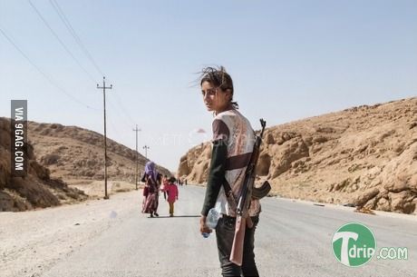 14 y.o. Kurdish girl carries rifle to protect her family.